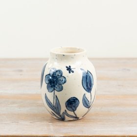 a delightful blue urn-style vase with charming floral patterns