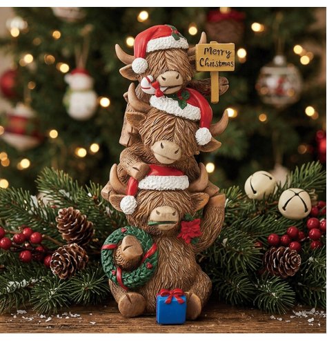 Embrace festive joy with this charming stacked Highland Cow family decoration