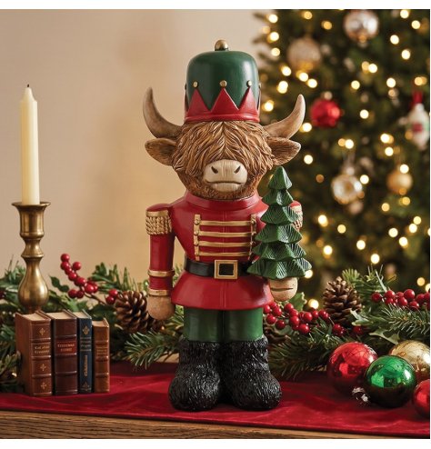 a delightful resin nutcracker featuring a highland cow character