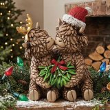 an endearing resin ornament featuring a darling pair of highland cows
