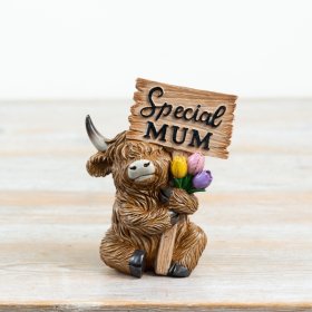 an endearing resin figurine of a Scottish Highland cow