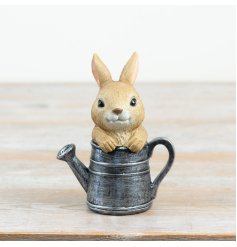 an endearing resin bunny poised in a watering can ideal for enhancing your outdoor space