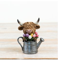 an endearing cow ornament nestled in a classic watering can ideal for garden display