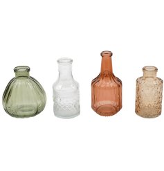 Four miniature vases in warm, sunlit hues perfect for brightening any space