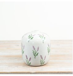  a stylish vase adorned painted lavender stems for a calm, natural aesthetic.