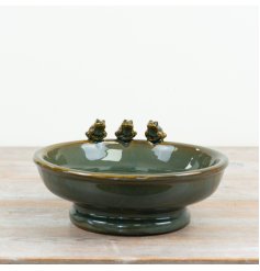 Delight your garden birds with this whimsical ceramic feeder adorned by playful frogs