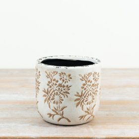 Bring a touch of retro charm to your greenery with this earthy floral patterned planter