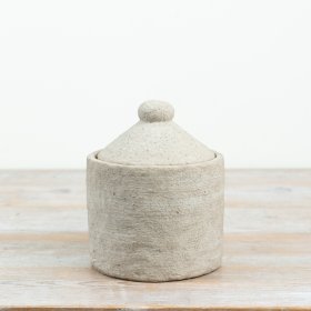 Bring a touch of natural simplicity into your space with this charming lidded container