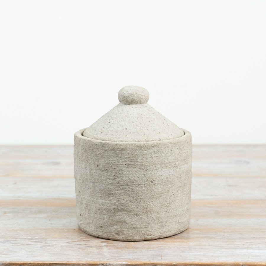 Bring a touch of natural simplicity into your space with this charming lidded container