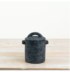 a rustic black storage jar with side handles and a sturdy lid