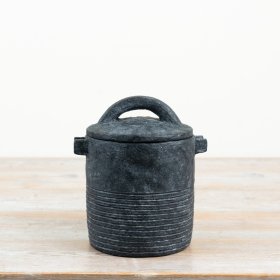 a charming black storage jar featuring a practical lid