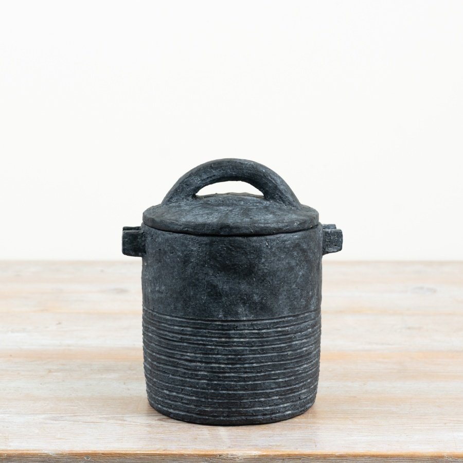a charming black storage jar featuring a practical lid