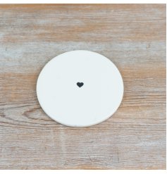 Pristine white coaster adorned with a stylish black heart in the centre