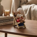 View Deck Chair Highland Cow Deco Details a fun Highland cow reading a book on a deck chair