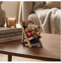 a fun Highland cow reading a book on a deck chair 