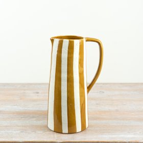 Bring a cheerful touch of Mediterranean sunshine into your space with this ochre-striped ceramic jug