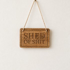 Add a playful touch to your garden or workshop with this amusing novelty plaque