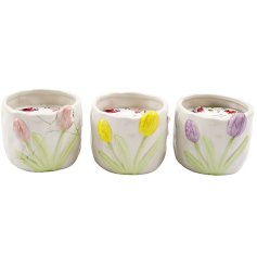 Delightful dolomite candle holders featuring soft-coloured tulip patterns