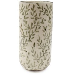 A softly coloured vase adorned with a delicate leafy pattern