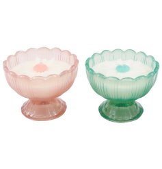 Graceful footed candles adorned with subtle floral patterns in soft pastel tones