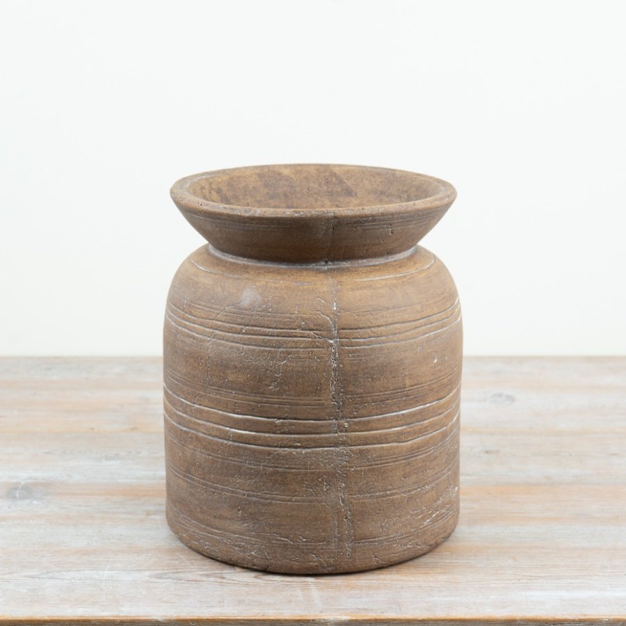 A distinctive terracotta vase with timeless churn-inspired character