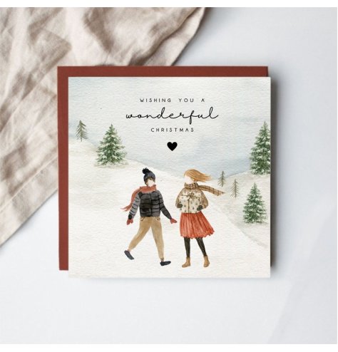 a delightful Christmas card capturing a snowy woodland stroll
