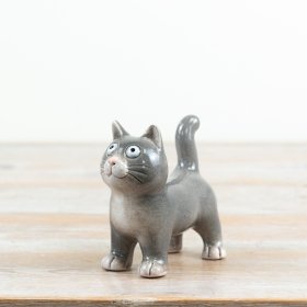 delightful glazed cat figure with amusingly large eyes
