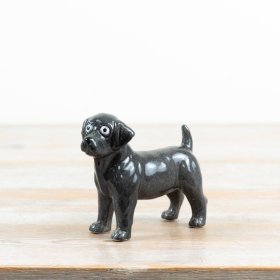 an endearing glossy puppy ornament with wide, expressive eyes