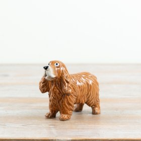 Glossy ceramic cocker spaniel with a cheerful wagging tail, ideal for cosy country interiors