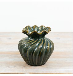  Elevate your contemporary or traditional home styling with this unique green ceramic fluted vase. 
