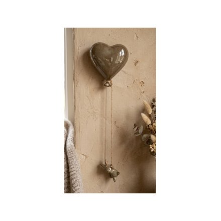 Charming ceramic heart with dangling rabbit, perfect for adding a sweet touch to your wall decor.
