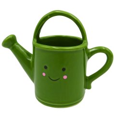 Adorable ceramic watering can with a cheerful smiley face, perfect for your garden or home décor