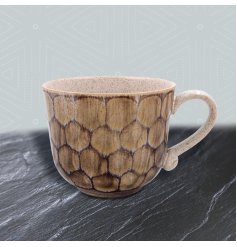 Cradle your favourite hot beverage in this beautifully crafted ceramic mug