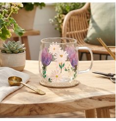 Delightful clear glass mug adorned with playful thistle and daisy motifs