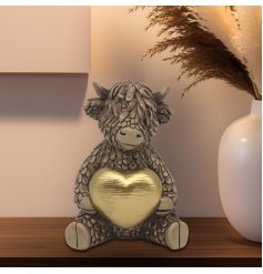Endearing Highland cow featuring a sparkling gold heart to add warmth to your space