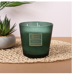 The candle is housed in a heavy frosted forest green glass jar that gives it an elegant, high-end feel. 