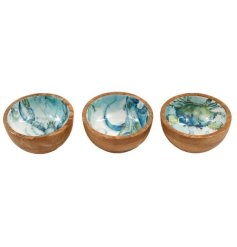 A beautifully crafted bowl featuring ocean-inspired enamel detailing on natural mango wood