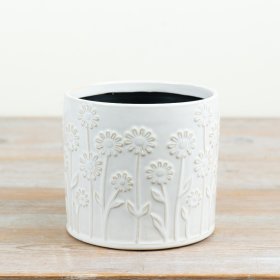 A white embossed planter that brings a charming finish to your favourite plants